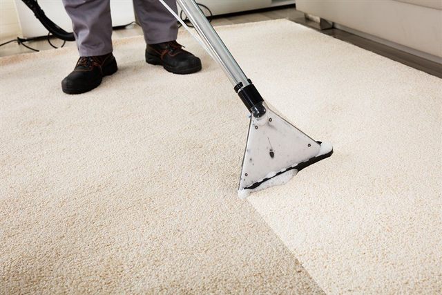 Carpet being deep-cleaned with a professional stainless-steel carpet wand in a Capitola home